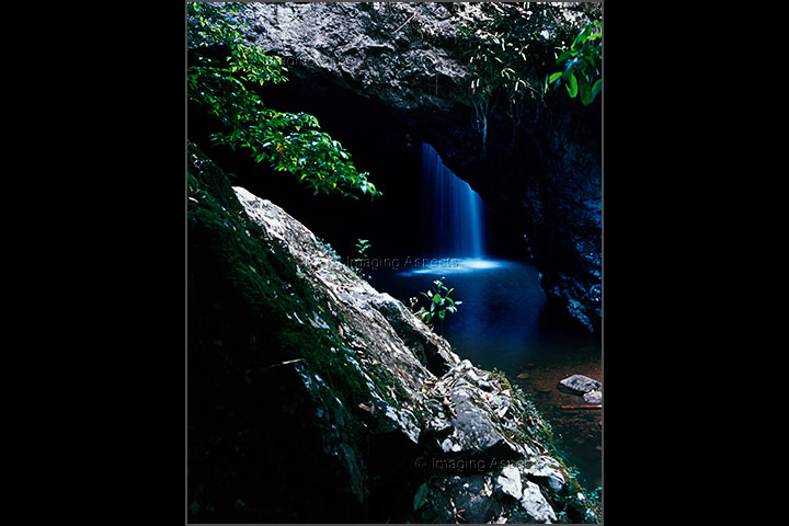 The Natural Bridge waterfall flows into a cave at Springbrook National Park, Queensland.